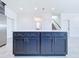 Modern kitchen island with dark blue cabinetry and quartz countertop at 2404 1/2 E Chelsea, Tampa, FL 33610