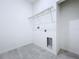 Laundry room with overhead shelving and gray tile floor at 2404 1/2 E Chelsea, Tampa, FL 33610