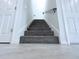 Gray carpeted stairs leading upstairs at 2404 1/2 E Chelsea, Tampa, FL 33610