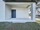 Covered back patio with concrete flooring and dark gray door at 2404 E Chelsea, Tampa, FL 33610