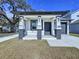 New construction home with a front porch and gray door at 2404 E Chelsea, Tampa, FL 33610