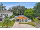 Charming house with gray and orange exterior, landscaped yard, and driveway at 4607 W San Jose St, Tampa, FL 33629