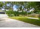 Landscaped backyard with lush greenery and a concrete patio at 4607 W San Jose St, Tampa, FL 33629