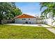 Spacious backyard with grassy lawn, fire pit, and covered patio at 4607 W San Jose St, Tampa, FL 33629