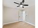 Spacious bedroom with ceiling fan and door to hallway at 4607 W San Jose St, Tampa, FL 33629