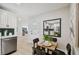 Bright dining area with a wooden table and four black chairs, near kitchen at 4607 W San Jose St, Tampa, FL 33629