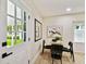 Bright dining area with a wooden table and four black chairs, near kitchen at 4607 W San Jose St, Tampa, FL 33629