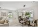 Open dining room with a glass table and stunning light fixture at 4607 W San Jose St, Tampa, FL 33629