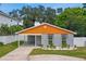 Modern home with gray brick, orange accents, and landscaped yard at 4607 W San Jose St, Tampa, FL 33629