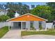 Modern home with gray brick, orange accents, and landscaped yard at 4607 W San Jose St, Tampa, FL 33629