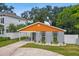 Modern home with gray brick, orange accents, and landscaped yard at 4607 W San Jose St, Tampa, FL 33629