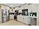 Modern kitchen with stainless steel appliances and white cabinets at 4607 W San Jose St, Tampa, FL 33629