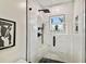 Elegant shower with marble walls and pebble floor at 4607 W San Jose St, Tampa, FL 33629