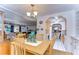 Dining area with wood table and chairs, kitchen access, and views into living room at 7141 El Matador St, Zephyrhills, FL 33541