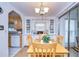 Bright dining area with wood table and chairs, built-in cabinetry, and kitchen views at 7141 El Matador St, Zephyrhills, FL 33541