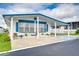 Front view of a white manufactured home with blue accents at 7141 El Matador St, Zephyrhills, FL 33541