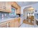 Open kitchen with wood cabinets and a view to the dining area at 7141 El Matador St, Zephyrhills, FL 33541