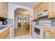 Bright kitchen with wood cabinets and tile flooring at 7141 El Matador St, Zephyrhills, FL 33541