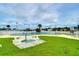 Community pool and spa with surrounding lawn at 7141 El Matador St, Zephyrhills, FL 33541