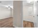 Bedroom with wood-look floors and access to another room at 3147 Calvano Dr, Land O Lakes, FL 34639