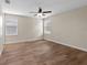 Bedroom with wood-look floors and ceiling fan at 3147 Calvano Dr, Land O Lakes, FL 34639