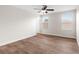 Well-lit bedroom with wood-look floors and ceiling fan at 3147 Calvano Dr, Land O Lakes, FL 34639