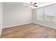 Bright bedroom with wood-look floors and two windows at 3147 Calvano Dr, Land O Lakes, FL 34639