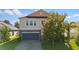 Two-story house with a stone and beige exterior, two-car garage, and landscaping at 3147 Calvano Dr, Land O Lakes, FL 34639