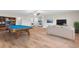 Game room with pool table, seating area, and wood-look floors at 3147 Calvano Dr, Land O Lakes, FL 34639