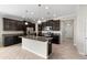 Kitchen with island, granite countertops, stainless steel appliances, and dark cabinets at 3147 Calvano Dr, Land O Lakes, FL 34639