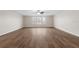 Spacious living room with wood-look floors and large windows at 3147 Calvano Dr, Land O Lakes, FL 34639