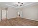 Bright and airy main bedroom with ceiling fan and wood floors at 3147 Calvano Dr, Land O Lakes, FL 34639