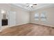 Main bedroom with wood floors and access to bathroom at 3147 Calvano Dr, Land O Lakes, FL 34639