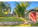 Large backyard with a storage shed and stone pathway at 5700 N Suwanee Ave, Tampa, FL 33604