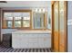 Clean bathroom, featuring a white vanity and wood-framed window at 5700 N Suwanee Ave, Tampa, FL 33604