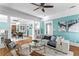 Living room with a light blue accent wall and hardwood floors at 5700 N Suwanee Ave, Tampa, FL 33604