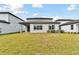 Spacious backyard with grassy lawn and covered patio at 1686 Fallon Pass, Zephyrhills, FL 33541