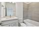 Bathroom with white vanity, quartz countertop and bathtub at 1686 Fallon Pass, Zephyrhills, FL 33541