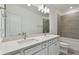 Double vanity bathroom with modern fixtures and grey tile at 1686 Fallon Pass, Zephyrhills, FL 33541