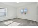 Well-lit bedroom with grey carpeting and two windows at 1686 Fallon Pass, Zephyrhills, FL 33541