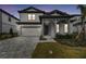 Two-story home with gray siding and a stone facade at 1686 Fallon Pass, Zephyrhills, FL 33541