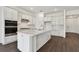 Modern kitchen with white cabinets, quartz countertops, and stainless steel appliances at 1686 Fallon Pass, Zephyrhills, FL 33541