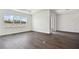 Spacious living room with large window and dark hardwood floors at 1686 Fallon Pass, Zephyrhills, FL 33541