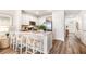 Stylish kitchen island with seating, white cabinets, and modern stainless steel appliances at 4309 Red Banks Ln, Bradenton, FL 34208