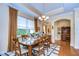 Bright dining room with hardwood floors and elegant chandelier at 2403 Richmond Greens Ct, Sun City Center, FL 33573