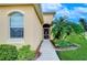 Charming front entrance with decorative door, well-maintained landscaping, and attractive facade at 2403 Richmond Greens Ct, Sun City Center, FL 33573