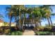 Beautiful gazebo surrounded by lush palm trees and landscaping, creating a serene outdoor space at 2403 Richmond Greens Ct, Sun City Center, FL 33573