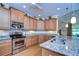 Spacious kitchen with granite countertops and stainless steel appliances at 2403 Richmond Greens Ct, Sun City Center, FL 33573