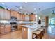 Large kitchen with granite counters, wood cabinets, and island at 2403 Richmond Greens Ct, Sun City Center, FL 33573