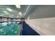 Indoor pool with a blue swimming lane and an open area at 2403 Richmond Greens Ct, Sun City Center, FL 33573